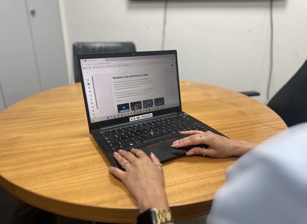 Employee using Kibi Connect at Alsco on a laptop in a meeting room
